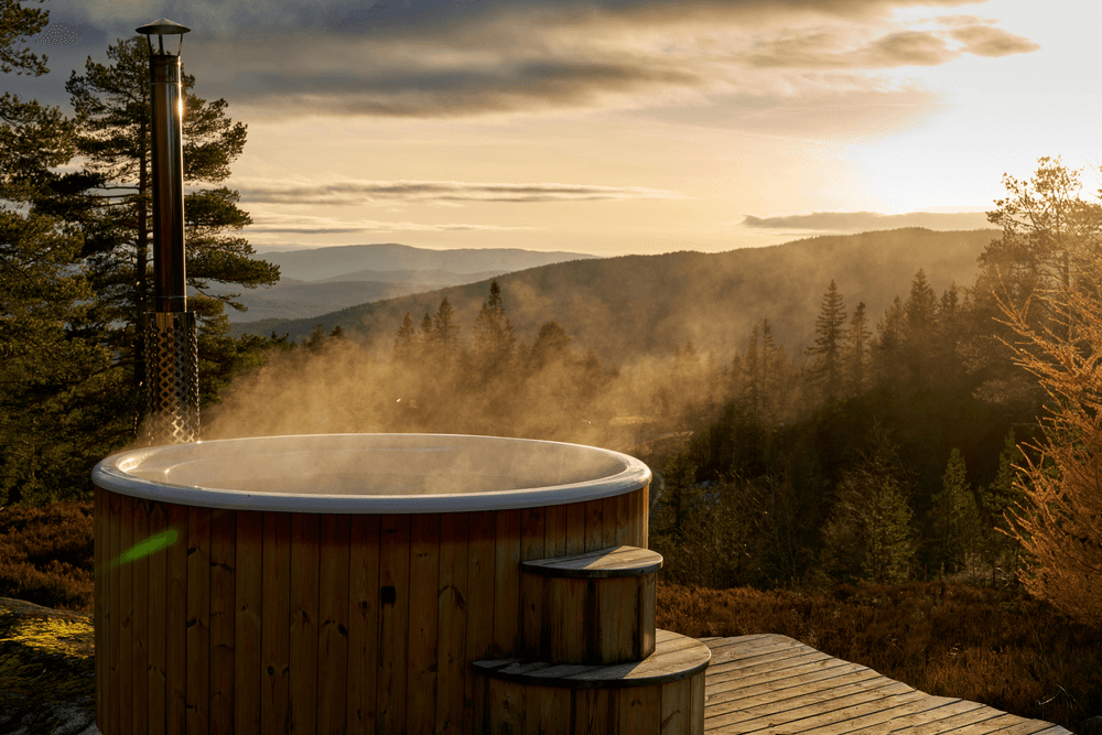 Wooden hot tub overlooking a misty valley