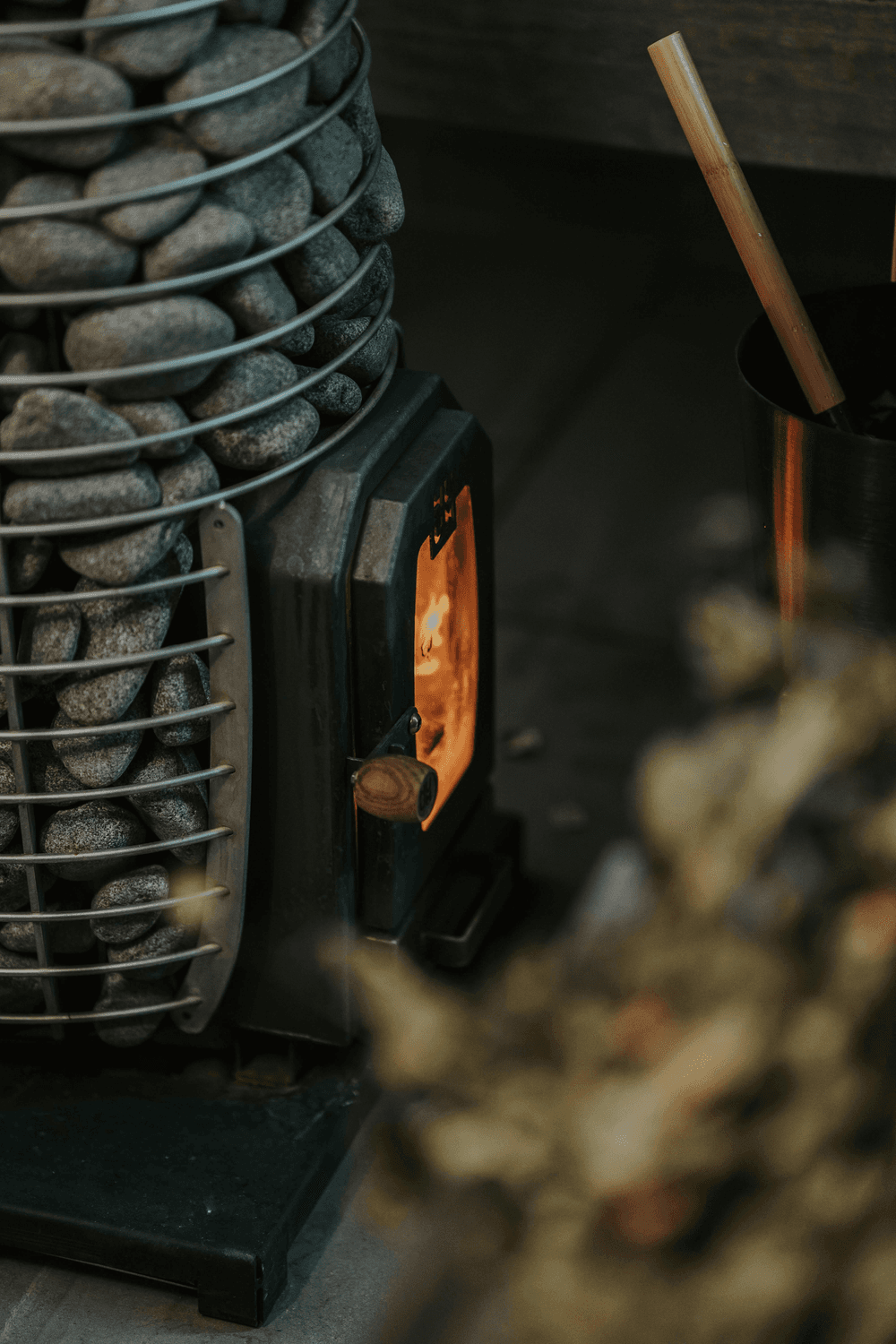 Close-up of a sauna stove with warm embers