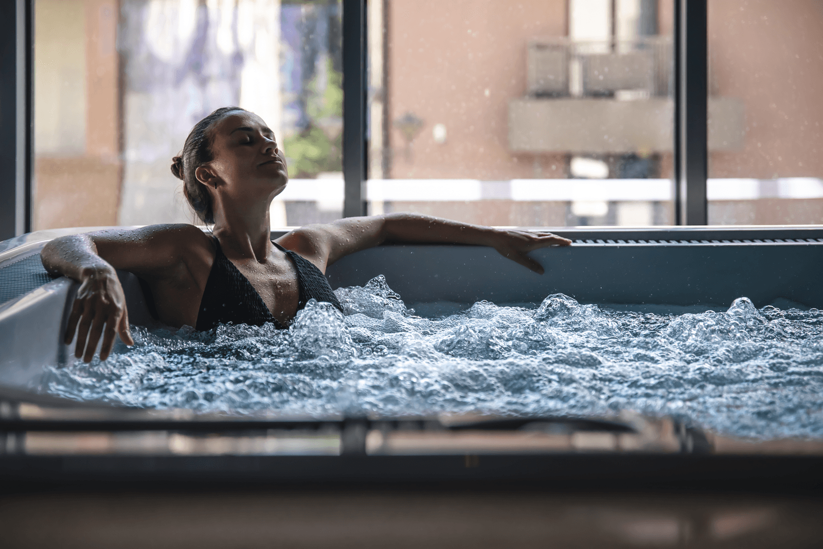 Woman relaxing in a hot tub